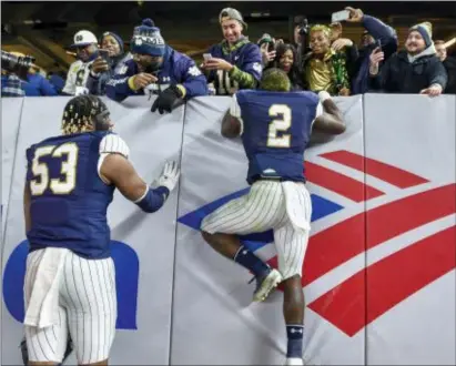  ?? HOWARD SIMMONS — THE ASSOCIATED PRESS ?? Notre Dame’s Dexter Williams (2) greets family and friends after Saturday’s game at Yankee Stadium in New York.