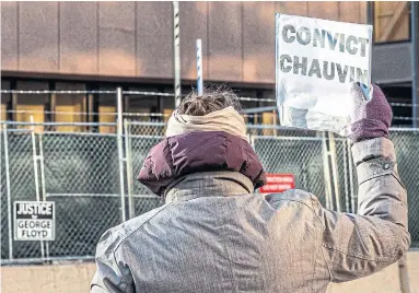  ?? KEREM YUCEL AFP VIA GETTY IMAGES FILE PHOTO ?? A woman protests outside the Minneapoli­s building where former police officer Derek Chauvin is on trial for murder.