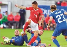  ?? AP ?? Switzerlan­d’s Steven Zuber (14) tries to go past Iceland’s players at Kybunpark stadium. Switzerlan­d won 6-0.