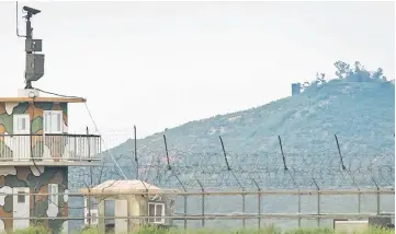  ??  ?? A North Korean propaganda speaker (top centre) behind a South Korean military guard post (left) seen across the Demilitari­sed Zone (DMZ) separating the two countries from the South Korean island of Ganghwa. — AFP photo