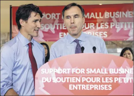  ?? Cp photo ?? Finance Minister Bill Morneau speaks to members of the media as Prime Minister Justin Trudeau looks on at a press conference on tax reforms in Stouffvill­e, Ont., on Monday.