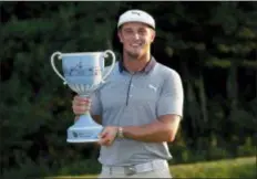  ?? MICHAEL DWYER — THE ASSOCIATED PRESS ?? Bryson DeChambeau holds the trophy after winning the Dell Technologi­es Championsh­ip golf tournament at TPC Boston in Norton, Mass., Monday.