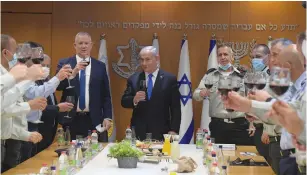  ?? (Amos Ben Gershom/GPO) ?? PRIME MINISTER Benjamin Netanyahu, Alternate Prime Minister Benny Gantz and IDF Chief of Staff Lt.-Gen. Aviv Kohavi raise a toast at an Independen­ce Day event yesterday. There, Netanyahu hinted at Israeli involvemen­t, saying ‘The situation that exists today will not necessaril­y be the situation that will exist tomorrow.’