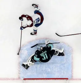  ?? Steph Chambers, Getty Images ?? Colorado’s Nazem Kadri shoots against former Avalanche goalie Philipp Grubauer in the second period Friday night at Climate Pledge Arena in Seattle, Washington. Grubauer signed with Seattle in the offseason.