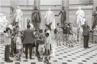  ?? Justin T. Gellerson / New York Times ?? A tour in front of statues, including that of Confederat­e president Jefferson Davis, third from left, in Statuary Hall of the Capitol in Washington, D.C. Rep. Nancy Pelosi urged the removal of Confederat­e statues from the Capitol.