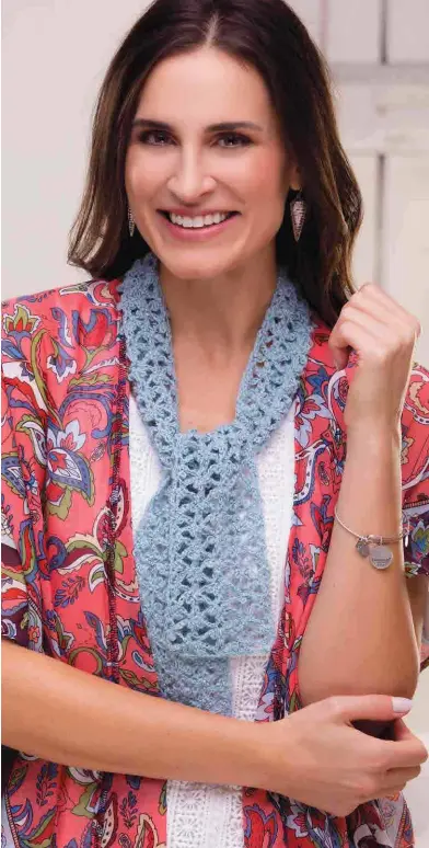  ??  ?? This lacy and delicate scarf features a pretty beaded blossom design crocheted in fingering-weight yarn. It’s perfect as an accent with a spring jacket, or crochet one using a handpainte­d cotton yarn for a summery look.