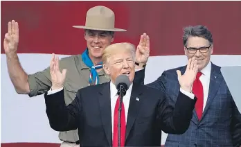  ?? Picture / AP ?? Donald Trump gestures with former boys scouts Interior Secretary Ryan Zinke (left) and Energy Secretary Rick Perry at the 2017 National Boy Scout Jamboree at Glen Jean, West Virginia.