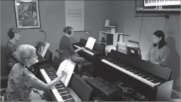  ??  ?? Pictured are piano students Jan McBain, front left, Gail McGinley, back left, and Nancy Watters, back right, taking a class taught by Amy Deal, owner of Calvert Piano located at 7021 South Flint Hill Road in Owings.