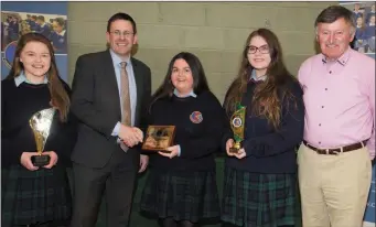  ??  ?? Principal Cathal Fitzgerald presenting awards to, from left, Aoife O’Connor, Emma Lawlor and Kate Austen-O’Sullivan with teacher Tim Leahy on right.