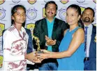  ?? ?? Best Player of the Final T. Sasmi of Mahajana College receiving her trophy from Dr. Manori Samarkoon