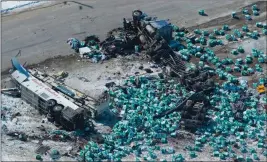  ?? ASSOCIATED PRESS ?? DEBRIS IS STREWN ABOUT at the scene of a fatal crash outside of Tisdale, Saskatchew­an, Canada, Saturday. A bus (left) en route to Nipawin carrying the Humboldt Broncos junior hockey team crashed into a truck Friday night, killing 14 and sending over a...