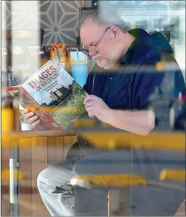  ??  ?? COMMITTED LONER: Meghan’s father Thomas Markle brushes up on his knowledge of Britain in a Mexican cafe – before his terrifying trip to her wedding