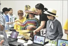  ?? SHARON BURNS PHOTO ?? Students and teachers pass out food samples related to their projects and showcase their knowledge via video presentati­on for Faith Academy’s History Exhibition on Friday, March 17, in Imperial.