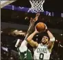  ?? Stacy Revere / Getty Images ?? The Celtics’ Jayson Tatum is defended by the Bucks’ Bobby Portis during the second quarter in Game 6 of the Eastern Conference Semifinals on Friday.