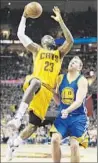  ?? Tony Dejak Associated Press ?? L eBRON JAMES of the Cavaliers shoots over David Lee of the Warriors.