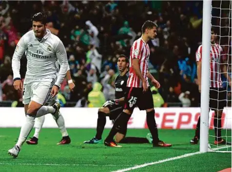  ?? AFP ?? Real Madrid’s forward Alvaro Morata (left) celebrates after scoring the late winner against Athletic Bilbao during the Spanish league match at the Santiago Bernabeu stadium in Madrid on Sunday.