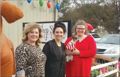  ?? SUBMITTED ?? From left, Kris Gravett, chair of the Arkadelphi­a Downtown Network; Jessica Arnold, owner of the Gossip Shop; and Humane Society of Clark County representa­tive Joy Buck, holding mascot Rex, pose in front of the Gossip Shop in Downtown Arkadelphi­a. The...