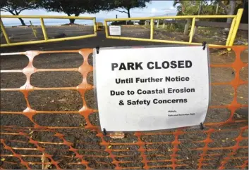  ?? The Maui News / MATTHEW THAYER photo ?? Puamana Beach Park is closed earlier this month. The park was set to reopen Sunday, but Maui County announced Friday that it would remain closed indefinite­ly due to coastal erosion and exposed Hawaiian burials.