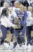  ?? RON SCHWANE — THE ASSOCIATED PRESS ?? Notre Dame’s Arike Ogunbowale (24) is mobbed by her teammates after making Friday’s game-winning shot.