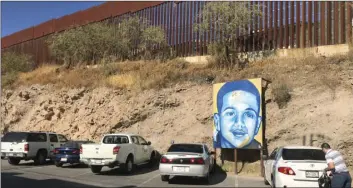  ??  ?? In this Dec. 4, 2017 photo, a portrait of 16-year-old Mexican youth Jose Antonio Elena Rodriguez, who was shot and killed in Nogales, Sonora, Mexico, is displayed on the street where he was killed that runs parallel with the U.S. border. AP PHOTO/ANITA...