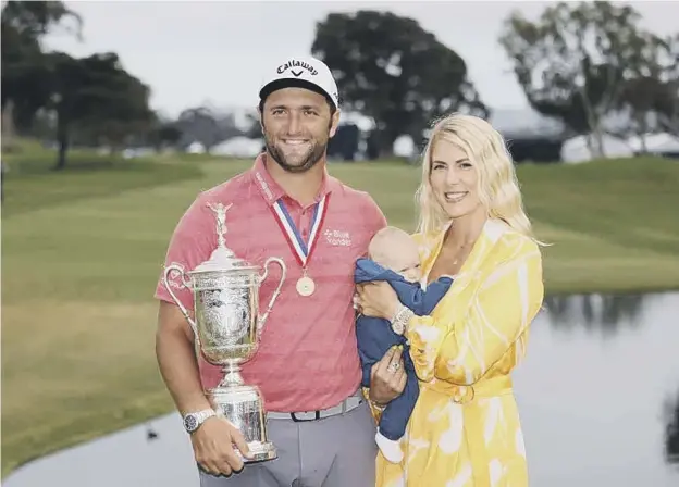  ??  ?? 0 Jon Rahm of Spain celebrates with the trophy alongside his wife, Kelley, and son, Kepa, after winning the 2021 US Open at Torrey Pines in San Diego, California
