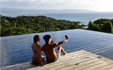  ?? ALEJANDRO ERNESTO/dpa ?? Tourists taking a selfie in a private villa in the Philippine­s. —