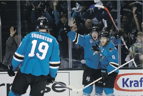  ?? MARCIO JOSE SANCHEZ/THE ASSOCIATED PRESS ?? San Jose Shark Tomas Hertl, middle, celebrates his goal with teammates Joe Pavelski and Joe Thornton during their 3-0 win over the St. Louis Blues in Game 3 of the Western Conference final on Thursday. San Jose leads the series 2-1.