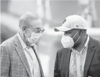  ?? DOUG MURRAY/ AP ?? Dolphins owner Steve Ross and general manager Chris Grier talk on the sidelines before Miami’s game against the Patriots on Dec. 20.