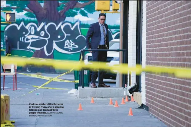  ?? BARRY WILLILAMS FOR NEW YORK DAILY NEWS ?? Evidence markers litter the scene in Tremont Friday after a shooting left one man dead and three people wounded.