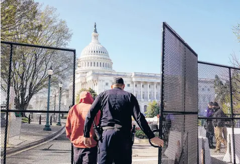  ?? AMR ALFIKY/THE NEW YORK TIMES ?? A Capitol Police officer opens a gate outside the Capitol building Saturday in Washington, near where a car rammed into a security barrier Friday, killing an 18-year veteran of the force. The driver was shot and killed.
