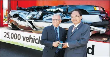  ?? PNG FILES ?? CEO of BC SCRAP- IT Dennis Rogoza ( left) and then B. C. Minister of State for Climate Change John Yap celebrate the firm’s 25,000th vehicle scrapped, at Richmond Auto Mall. Replacing a 1995 or older vehicle cuts greenhouse gas emissions.