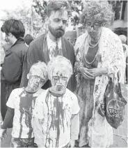  ??  ?? Freaky-looking families were a common sight at this year’s event. Seven-year-olds Eli Duncan, left, and Jack Duncan got into the zombie spirit with Shane Duncan, back left, and Jack Lemaistre.