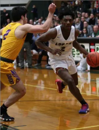  ?? RANDY MEYERS — FOR THE MORNING JOURNAL ?? Lorain’s Taevon Pierre-Louis drives past Joey Lance of Avon during the first quarter of a district semifinal on March 6.