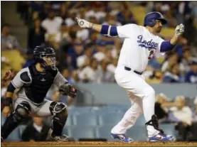  ?? ALEX GALLARDO - THE ASSOCIATED PRESS ?? FILE - In this Sept. 26, 2017, file photo, Los Angeles Dodgers’ Adrian Gonzalez, right, follows through on his double with San Diego Padres catcher Luis Torrens watching during the second inning of a baseball game, in Los Angeles.