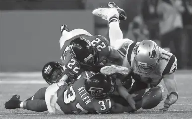  ?? Associated Press photos0 ?? In this Feb. 5 file photo, New England Patriots' Julian Edelman (11) makes a catch as Atlanta Falcons' Ricardo Allen and Keanu Neal defend, during the second half of the NFL Super Bowl 51 football game in Houston. Down by eight points with about two...