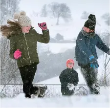  ??  ?? Allie and Ciall Flynn enjoying the snow and the day off school in Slane, Co Meath, yesterday. Photo: David Conachy.