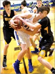  ?? Westside Eagle Observer/MIKE ECKELS ?? Decatur’s Cayden Bingham (center) holds on to a rebound as a Yellow Jacket player tries to strip it away during the second quarter.