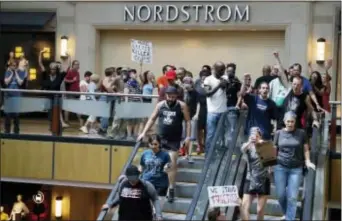  ?? JEFF ROBERSON - THE ASSOCIATED PRESS ?? Protesters march through West County Mall in response to a not-guilty verdict in the trial of former St. Louis police officer Jason Stockley Saturday, in Des Peres, Mo. Stockley was acquitted on Friday in the 2011 killing of Anthony Lamar Smith, a...