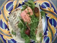  ??  ?? COURTESY BIBBY GIGNILLIAT
Whether you roast the salmon or grill it, these sensationa­l pita sandwiches brim with flavor, thanks to a black-olive aioli and fresh cherry tomatoes.