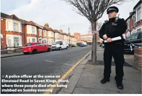  ??  ?? > A police officer at the scene on Elmstead Road in Seven Kings, Ilford, where three people died after being stabbed on Sunday evening