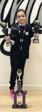  ??  ?? Moving on up Dance soloist Niah Crawford, 12, shows off her trophies