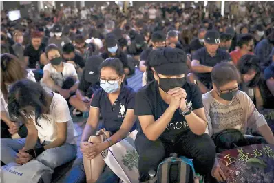  ?? AP Photo/Mark Schiefelbe­in ?? ■ Protesters attend a prayer rally Saturday at Edinburgh Place in Hong Kong. Hong Kong pro-democracy protesters are set for another weekend of civil disobedien­ce as they prepare to hold an unauthoriz­ed protest march to press their demands.