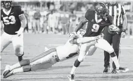  ?? STEPHEN M. DOWELL/ORLANDO SENTINEL ?? UCF running back Adrian Killins Jr. drags SMU safety Mikail Onu into the end zone during a 15-yard, first-quarter touchdown run at Spectrum Stadium.