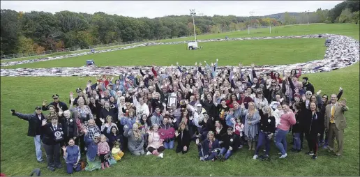  ?? Call file photo by Ernest A. Brown ?? A large crowd of family, friends, volunteers join Jennifer Jolicoeur for a group photo in front of the 196,564 bra chain following the World Record announceme­nt in 2019.