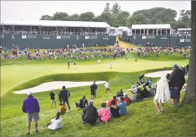  ?? Catherine Avalone / Hearst Connecticu­t Media ?? Brian Harman and Matt Jones on the green of the 18th hole during the third round of the Travelers Championsh­ip at TPC River Highlands in Cromwell on Saturday.