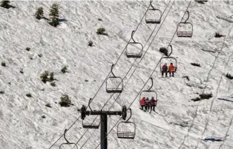  ?? Brian Walker/Special to The Chronicle ?? Skiers and snowboarde­rs ride the Madden Triple Chair at Homewood Resort.