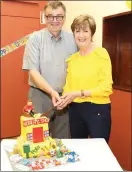  ??  ?? Donal and Nuala Riordan cutting the cake at a function in their honour.