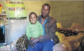  ?? PHOTO: SIMPHIWE NKWALI ?? Christophe­r Mazibuko and his son Blessing in Louieville outside Barberton in Mpumalanga. His wife, Pretty Nkambule, is buried under the collapsed Lily Mine.