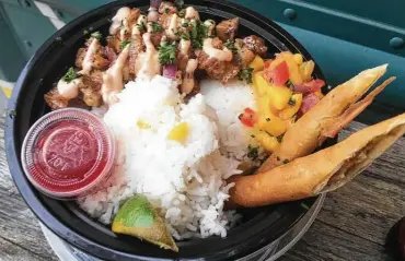  ?? Photos by Chuck Blount / Staff ?? The sisig bowl is a kind of sampler, with two lumpia, cubes of pork belly, jasmine rice and mango salsa.