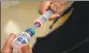  ?? Mel Melcon / TNS ?? A vial containing the MMR vaccine is loaded into a syringe.